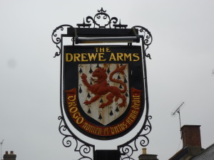 The lettering from a Home and Colonial shop front, on display at Castle Drogo, and the coat of arms outside the inn at Drewsteignton .
